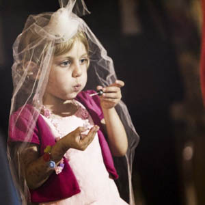 fotografo stile reportage a Roma, la bambina si allena a soffiare le bolle di sapone per quando gli sposi usciranno dalla chiesa presso il duomo di Bracciano